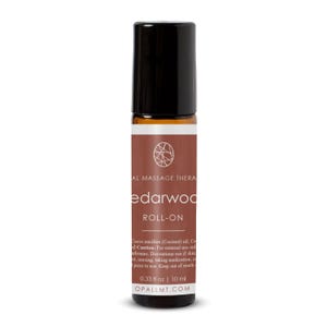 May include: A small amber glass roll-on bottle with a black cap and a brown label. The label features a white circular logo, the text "cedarwood ROLL-ON", and "0.33 fl oz | 10 ml" printed at the bottom, along with additional small white text.