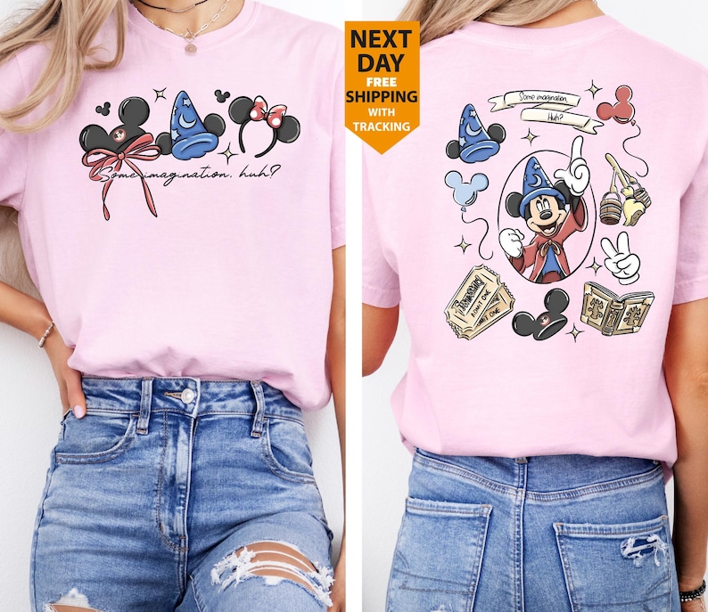 May include: A light pink t-shirt featuring Disney-themed graphics. The front displays Mickey Mouse ears, a wizard hat, and Minnie Mouse ears with text that reads "Some imagination, huh?" The back showcases Mickey Mouse as a wizard.