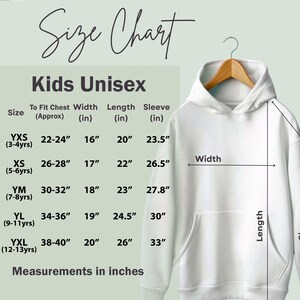 May include: A white Kids Unisex hoodie displayed on a wooden hanger. The image includes a size chart with measurements in inches for chest, width, length, and sleeve. The chart is labeled "Size Chart" and includes sizes from YXS to YXL.
