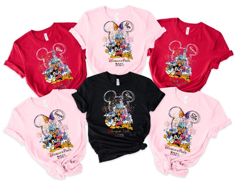 May include: Six pink, red, and black t-shirts with a Mickey Mouse design and the text "Disneyland Paris 2023". The shirts have different names on them, including "Mom", "Dad", "Grandma", "Grandpa", and "Sis".