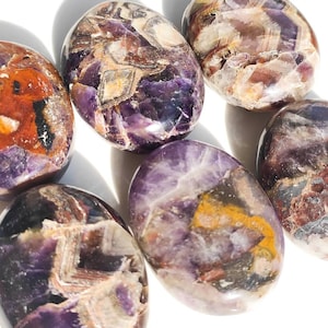 May include: Six smooth, polished amethyst stones with a variety of purple, brown, and white patterns. The stones are oval shaped and have a glossy finish.
