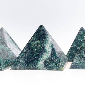 May include: Five green and white marbled pyramid-shaped crystals.