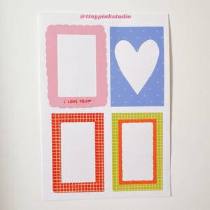 May include: A sheet of stickers featuring four designs. One pink scalloped frame with "I LOVE YOU" text, a blue square with a white heart, and two rectangular frames with orange and green borders. The top text reads "@tinypinkstudio".
