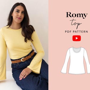 May include: A woman wearing a yellow long-sleeve top with flared sleeves and a brown belt. The top is paired with dark blue jeans. The image also includes a graphic of a white long-sleeve top with the text "Romy top PDF PATTERN" and a YouTube logo.