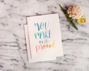 Multicolor Watercolor Lettered "You Make Us Proud" Congratulations Card Greeting Card