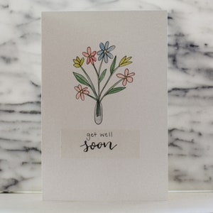 Fleurs d’aquarelle à la main écrit get Well Soon Carte de salutation