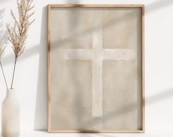 May include: A framed beige canvas print with a white cross painted on it. The canvas is in a light wood frame.