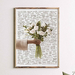 May include: A framed print of a hand holding a bouquet of white roses. The background is a white page filled with handwritten text.