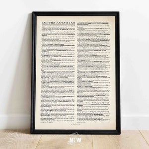 May include: A black framed print with a white background and black text. The text reads "I AM WHO GOD SAYS I AM" and includes several bible verses. The print has a "NEW" sticker in the bottom right corner.