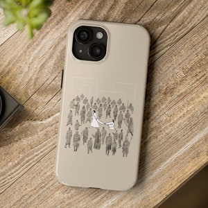 May include: A beige iPhone case with a black and white illustration of a couple dancing in a crowd of people.