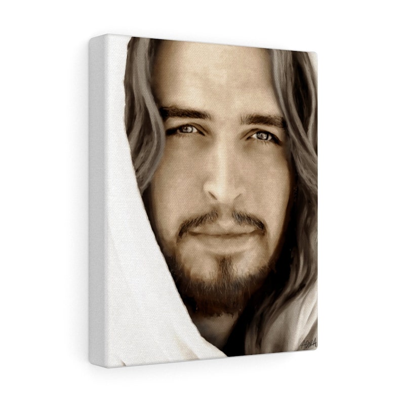 May include: A close-up portrait of a man with long brown hair and a beard. He is wearing a white robe and looking directly at the viewer. The image is in sepia tones.