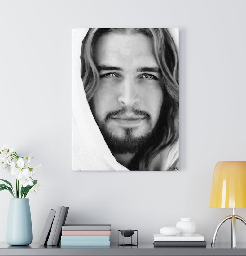 May include: Black and white portrait of a man with long hair and a beard. He is wearing a white robe and looking directly at the viewer. The image is a close-up of his face.