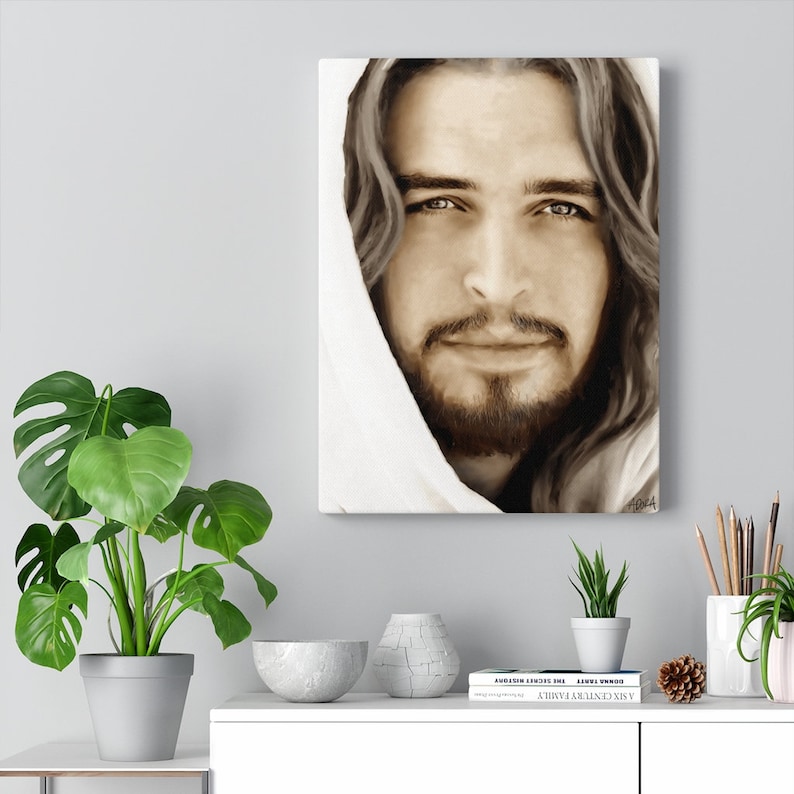 May include: A painting of a man with long brown hair and a beard, wearing a white robe. He is looking directly at the viewer with a gentle expression. The painting is done in a realistic style and has a warm, inviting feel.