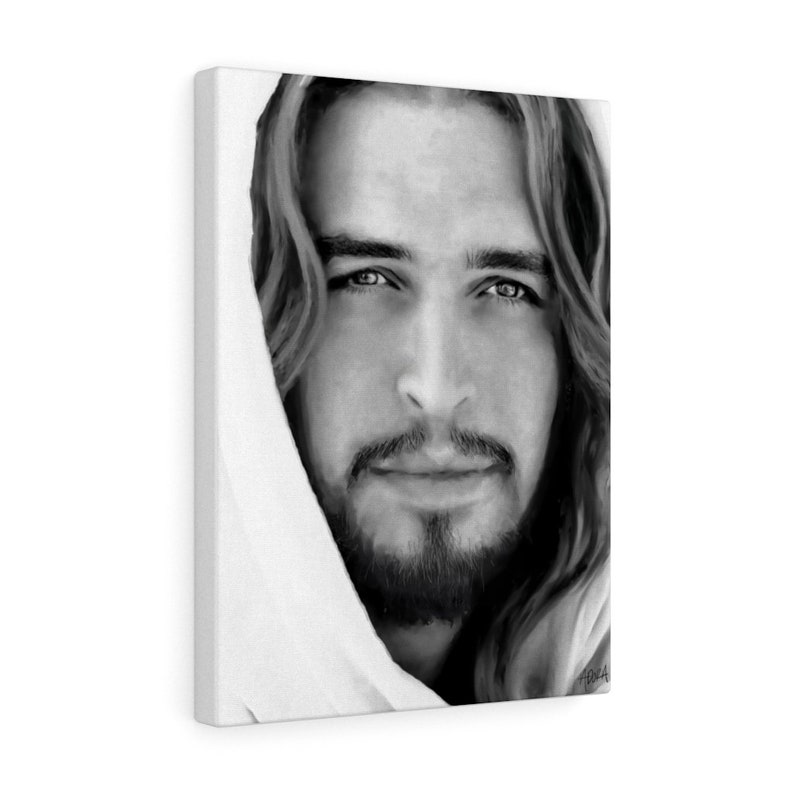 May include: Black and white portrait of a man with long hair and a beard. He is looking directly at the viewer with a serious expression. The image is cropped to show only his face and shoulders.