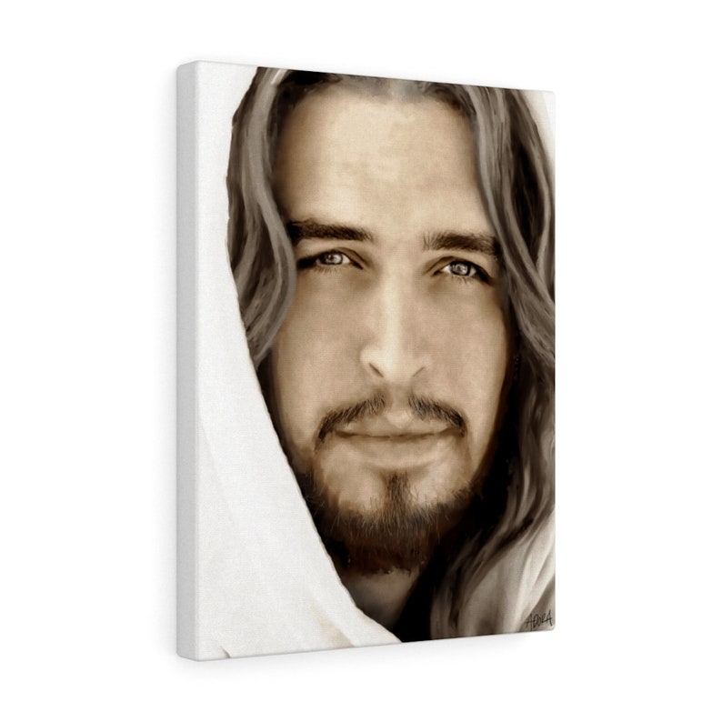 May include: A close-up portrait of a man with long brown hair and a beard. He is wearing a white robe and looking directly at the viewer. The image is in sepia tones.