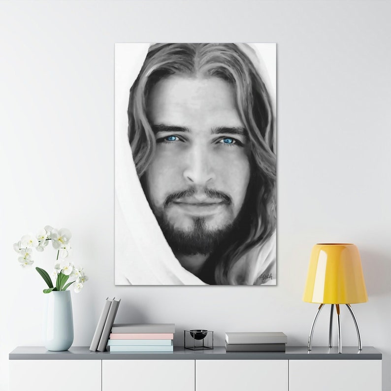 May include: Black and white portrait of a man with long hair and a beard. He is wearing a white robe and has blue eyes. The image is in a minimalist style.