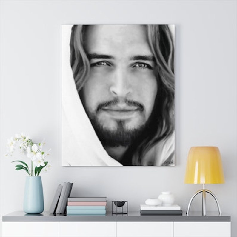 May include: Black and white portrait of a man with long hair and a beard, wearing a white hooded robe. The man's eyes are looking directly at the viewer.