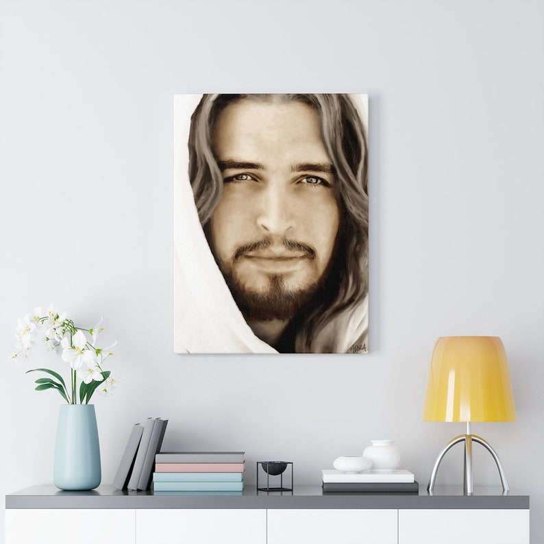 May include: A sepia toned portrait of a man with long hair and a beard, wearing a white robe. His eyes are looking directly at the viewer.