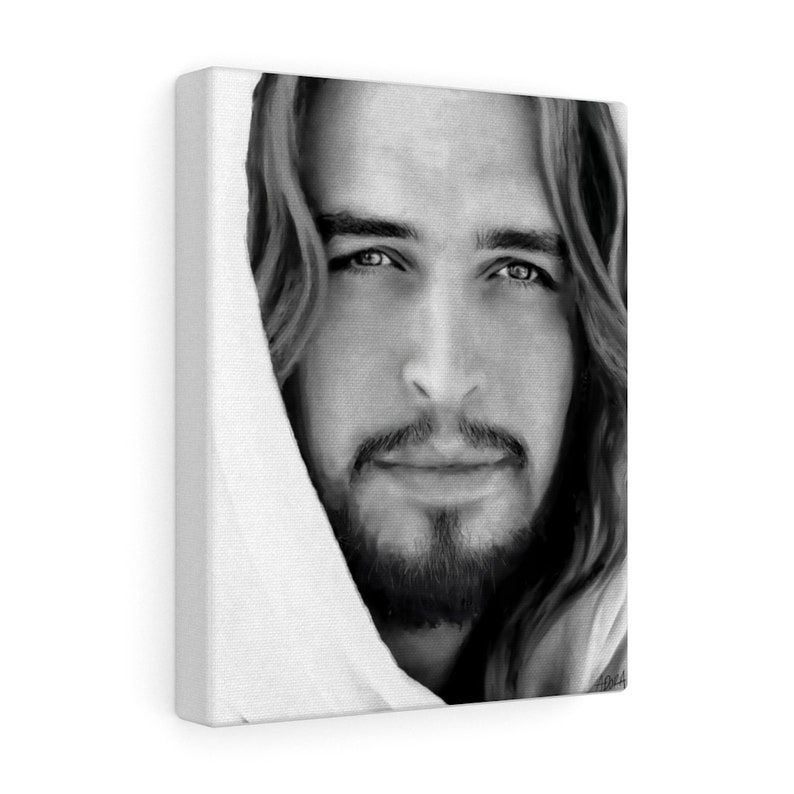 May include: Black and white portrait of a man with long hair and a beard. He is wearing a white robe and looking directly at the viewer.