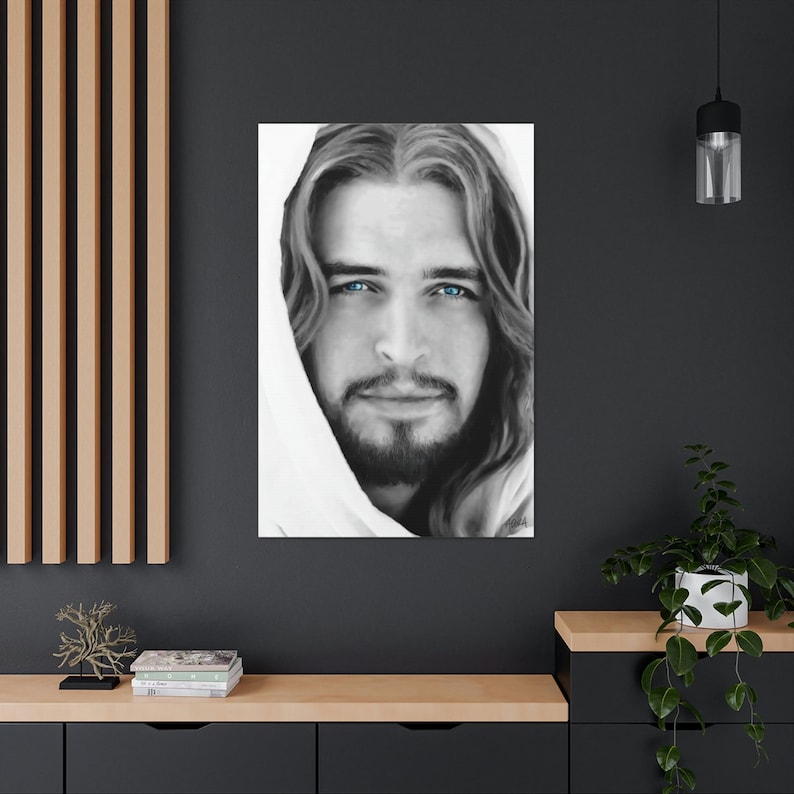 May include: Black and white portrait of a man with long hair and a white robe. His eyes are blue.