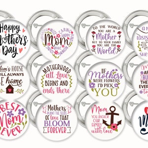 May include: Ten round white button pins with silver borders and backs. Each pin features a different design with text and floral accents. The text on the pins includes phrases like "Happy Mother's Day", "Mom", "Motherhood", "Best Mom Ever", and "To the World You Are a Mother".