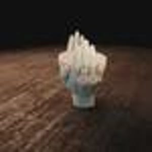 May include: A white, abstract sculpture of a hand with fingers pointing upwards. The sculpture is made of a textured material and sits on a brown surface. The hand appears to be reaching or gesturing.