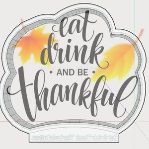 Puede incluir: Un diseño blanco en forma de nube con un contorno gris y el texto "eat drink and be thankful" en una fuente estilizada. El fondo presenta un diseño de estilo acuarela de hojas naranjas y amarillas.