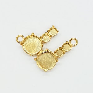 May include: Gold-toned metal connector with five round settings for attaching stones or charms. The connector has a loop on one end for attaching to a chain or bracelet.