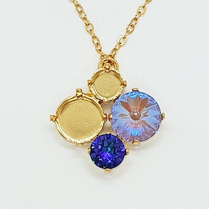 May include: A gold chain necklace with a pendant featuring three round settings, two with clear glass stones and one with a purple stone.