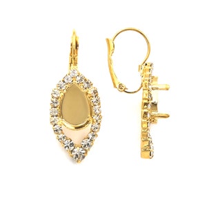 May include: Gold tone earring with a teardrop shaped setting surrounded by clear rhinestones. The earring has a lever back closure.