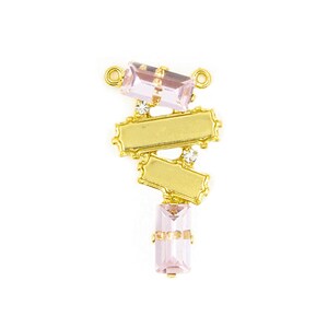 May include: Gold pendant with pink and clear crystals. The pendant features a geometric design with three rectangular shapes and two rectangular crystals.