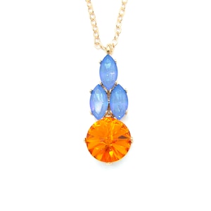 May include: A gold chain necklace with a pendant featuring a large orange crystal surrounded by four smaller blue crystals.
