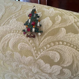 Weiss 1950’s Christmas tree brooch, 2 ornament  on bottom, 5 baguette shaped stones on tree, SOLD AS Is,(Signature confirmation required)