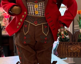 Santa Claus dressed in German style clothing,lederhosen, feather in cap, nutcrackers in basket (Signature Confirmation Required)