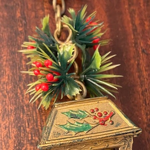 Vintage mid century Christmas ornament hanging plastic lantern with faux red candle and greenery