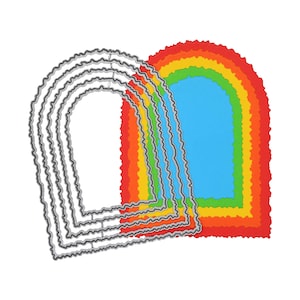 May include: A set of four nested metal cutting dies with scalloped edges, each featuring an arched shape. Beside the metal dies is a set of four corresponding arched paper cutouts in vibrant red, orange, yellow, green, and blue colors.