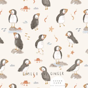 May include: A repeating pattern featuring watercolor illustrations of puffins, crabs, starfish, and shrimp on a cream background. The puffins are depicted in various poses, some standing on rocks. The text "LUMELO AND GINGER" and "220 MM CARD NON EXCLUSIVE" are also present.