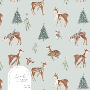 May include: A seamless pattern featuring a light blue background with a repeating design of brown deer wearing scarves, green pine trees, and gold stars. The text "Lumelo & Ginger Design Studio 2023" is in a white circle at the bottom of the pattern.