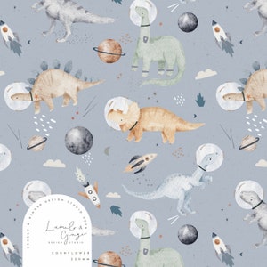 May include: A seamless pattern featuring dinosaurs in space helmets, planets, stars, and rockets on a light blue background. The pattern includes the text "Lumelo & Ginger Design Studio 2021" and "Cornflower 220mm".