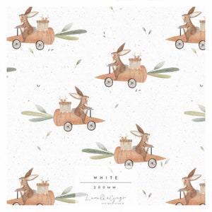 May include: A seamless pattern featuring cute brown bunnies driving orange carrot cars with green leaves. The background is white with a subtle speckled texture. The text "WHITE 200MM Lumila & Ginger DESIGN STUDIO" is at the bottom of the pattern.