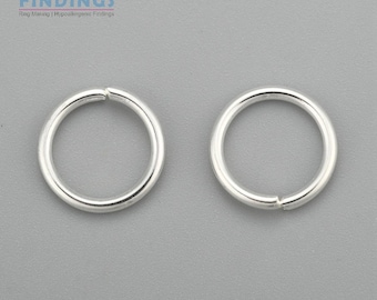 May include: Two silver jump rings, each with a diameter of approximately 1/2 inch. These rings are commonly used in jewelry making.