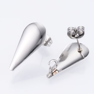 May include: A pair of silver teardrop-shaped stud earrings with a post and butterfly backing.