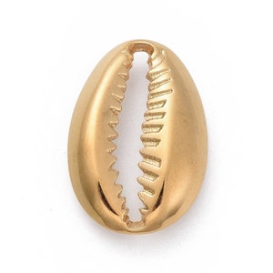 May include: A gold-coloured cowrie shell pendant charm. The shell is smooth and shiny with a detailed, textured design.