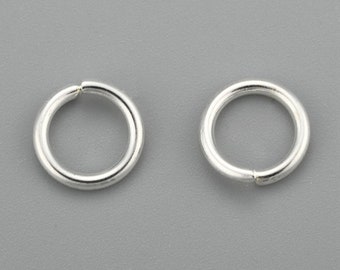 May include: Two silver jump rings, each with a diameter of approximately 1/2 inch.