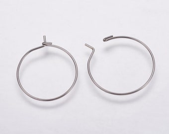 May include: A pair of silver hoop earrings with a hinged closure.
