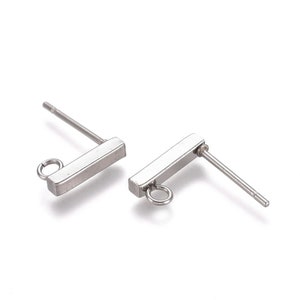 May include: Two silver earring posts with a rectangular bar and a small loop at the end. The posts are designed to be used with a variety of earring charms.