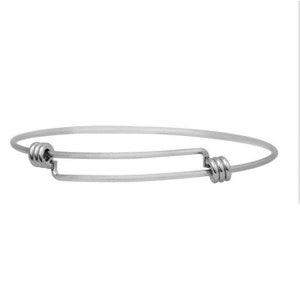 May include: A silver expandable bracelet with a simple design. The bracelet has two round clasps on either end.