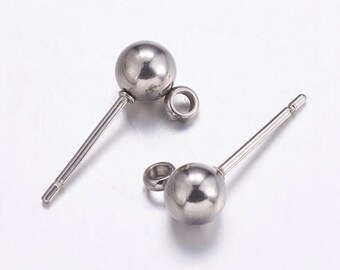 May include: Two silver earring posts with a round ball at the top and a loop at the bottom. The posts are made of metal and are designed for use with earrings.