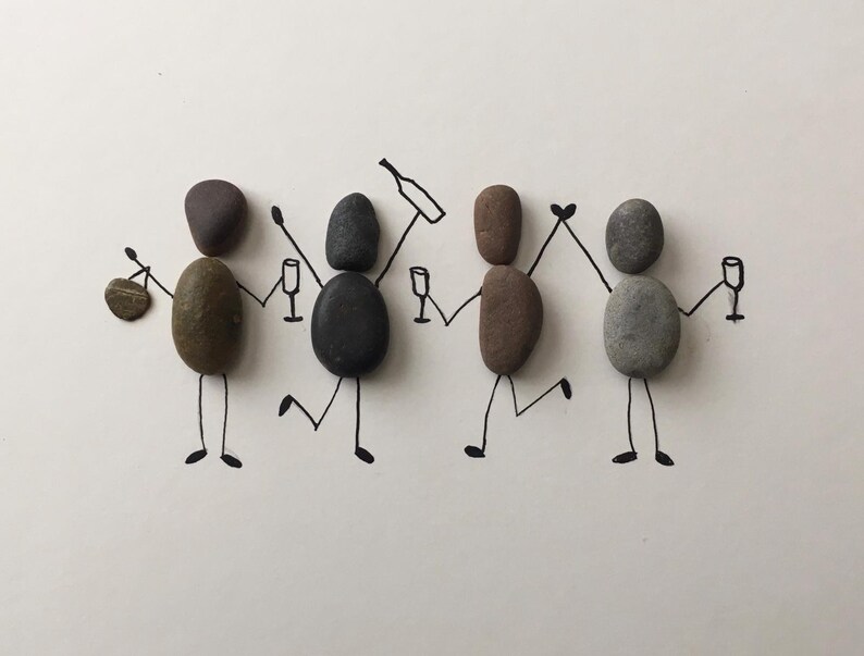 May include: A whimsical illustration of four figures crafted from smooth stones, each with a unique color and shape. They are depicted holding hands and celebrating with wine glasses and a bottle, all drawn with black lines on a white background.