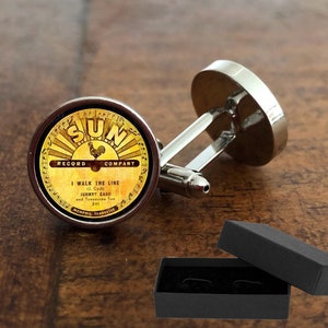 May include: Silver cufflinks with a round, black and gold Sun Record Company label featuring a rooster and the text "I Walk the Line (J. Cash) Johnny Cash and Tennessee Two 241".
